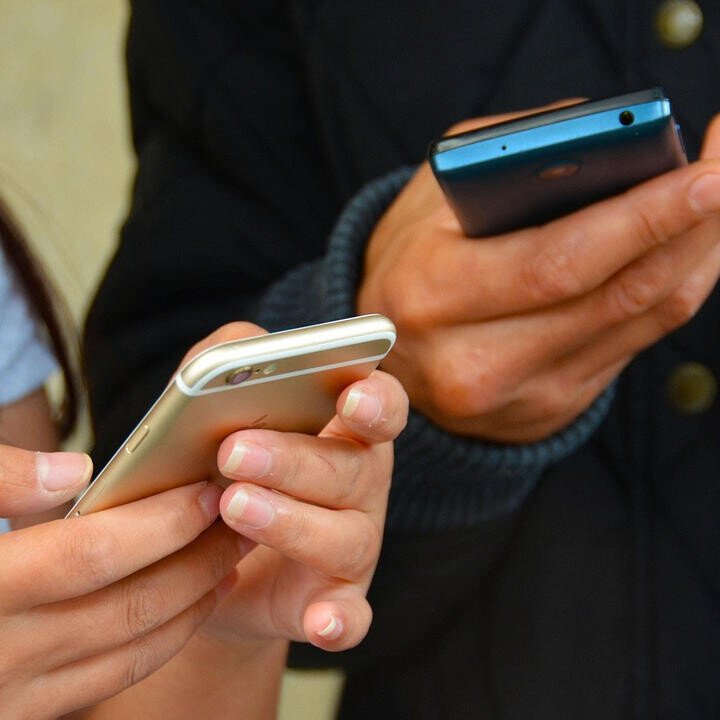 hands holding mobile phones